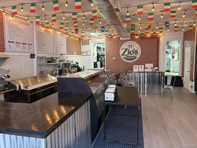 Zio's Market deli counter, menu boards, and Italian flag string lights