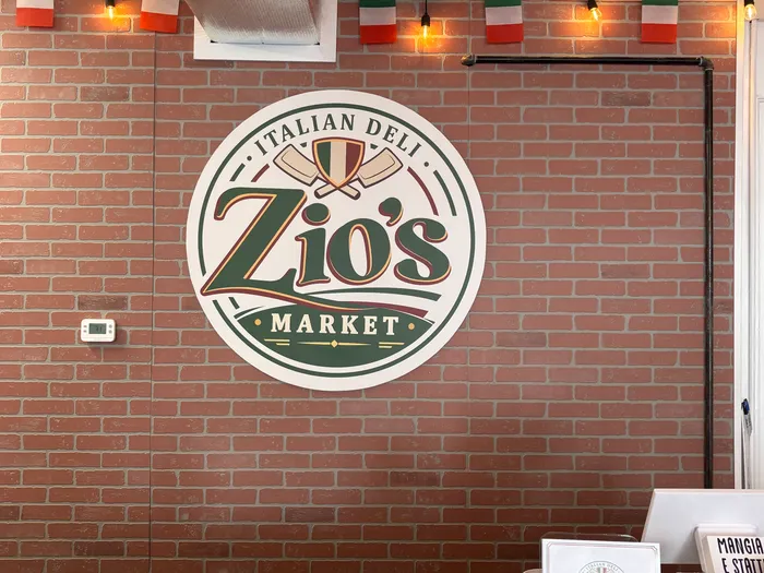 Zio's Market logo painted on the exposed brick wall inside the shop